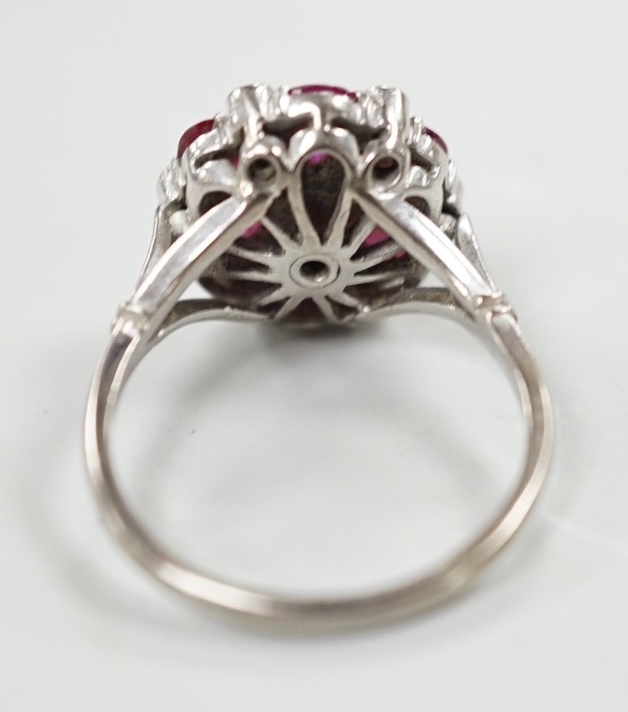 An 18ct & plat, pear cut ruby and diamond chip cluster set ring, size N/O, gross weight 4.8 grams.